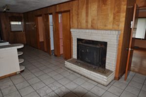 View of kitchen fireplace before renovations